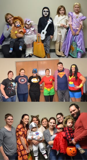 Employees and kids dressed in Halloween costumes