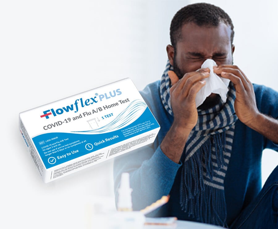 Man with Covid-19 blowing his nose. Covid-19 and Flu Home Test
